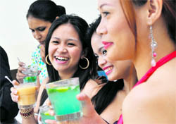Girls relish mango drinks during the mango fest at a hotel in Ludhiana