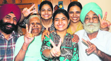 Harsimar Kaur, who stood first in the pre-medical test, with her mother, father and relatives in Chandigarh 