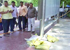 People gather at the site where a bag containing suspicious material was found outside Gargi College in New Delhi on Monday