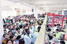 Applicants throng the general post office to get forms for recruitment to Class III posts in the state government in Dehradun on Monday