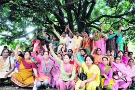 Anganwari workers hold a protest in support of their demands at Gandhi Park, Dehradun, on Monday