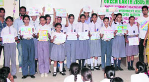 Students show their paintings on Save Environment at Smt. Sugni Devi Arya Girls Senior Secondary School, Ladwa, 20 km from Kurukshetra. 