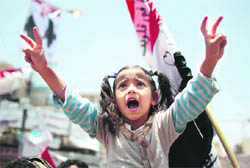 A girl joins anti-government protesters as she shout slogans during a rally in Sanaa on Monday.