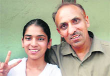 Neha Kamal, who has topped in the matric exam of the Haryana Board of School Education by securing 97.6 per cent marks, along with her father at Panchkula.