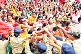 Anganwari workers stage a protest in support of their demands in front of the residence of the Uttarakhand Chief Minister in Dehradun on Tuesday