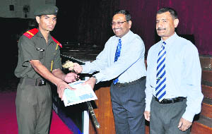 Maj-Gen AK Mudholkar gives an award to a cadet at the  graduation ceremony of the Rashtriya Indian Military College,Dehradun