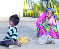 A woman smokes a bidi at the railway station in Ahmedgarh