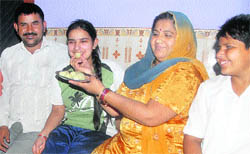 Rekha, who secured CGPA 9.2 in the CBSE class X examination, celebrates her success with parents in Chandigarh on Wednesday