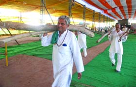 Followers of Baba Ramdev take part in the prepration for a yog shivir at the Ramlila Grounds in New Delhi