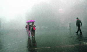 People enjoy a walk amid dense fog in Shimla