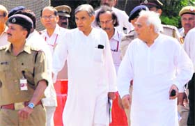 Union ministers Kapil Sibal and Pawan Kumar Bansal after meeting Baba Ramdev at the IGI Airport in New Delhi on Wednesday