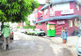 A car parked in front of a health clinic in a residential area in Patiala. 