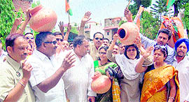 Congress workers stage a protest against inadequate water supply in Dehradun on Thursday.