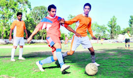 Players try to take control of the ball in a match in the Lala Nemi Dass Memorial Dehradun District Football League in Dehradun on Thursday.