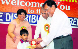 Social activist AD Gandhi gives away prize to a student during the annual prize distribution function of PKR Jain Vatika in Ambala City.