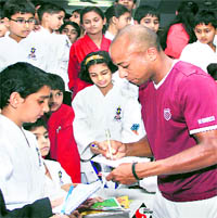 Nicholas, who is 169th ranked tennis player in thw world gives autographs to students of Sanjay Karate School during his visit to Jalandhar