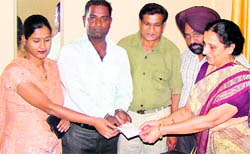 Director Social Welfare Department, Punjab, Indu Mishra hands over a cheque to a couple under the Shagan Scheme in Ropar on Thursday