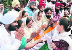 Members of the Sikh delegation meet UPA chairperson Sonia Gandhi in New Delhi on Thursday. Led by Delhi Sikh Gurdwara Management Committee chief Paramjit Singh Sarna and accompanied by Delhi Chief Minister Sheila Dikshit, the delegation thanked the Congress leader for the government's decision regarding removal of the names of 142 Sikhs from the blacklist