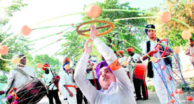 A devotee exhibits his gatka skills during a procession to mark the martyrdom day of Guru Arjan Dev in Mohali on Friday.