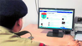 A constable checks out the profile of the Chandigarh Traffic Police on Facebook at Police Lines in Chandigarh on Friday.