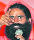 Ramdev addresses supporters in New Delhi on Friday.