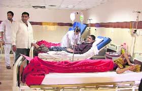 Manohar Lal, a resident of Abohar and father of a 17-year-old cancer patient, waits for a nurse at the paediatric ward, while his son lies on the bed