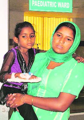Charanjeet with her daughter Sunita waits for the reports in Ludhiana
