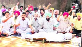 Up in arms Members of the Powercom Employees Union stage a dharna against the Powercom management in support of their demands at Jagraon on Friday