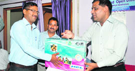 Dr Rajesh Naithani (right), adviser to the Uttarakhand Chief Minister, gives away a computer to a representative of SGGR PG College at a function in Dehradun on Saturday.