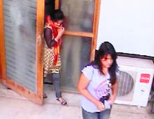 Two teenagers emerge from a cyber cafe in Dugri soonafter a police raid on the premises.