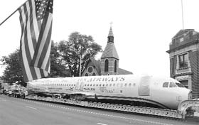US Airways flight 1549, also known as the Miracle on the Hudson, is hauled on a truck through the streets of Elizabeth, New Jersey, on Saturday