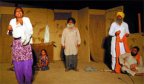 A scene from the Punjabi play Ret Dian Kanda staged by the Norah Richard group at the open theatre in the Rose Garden on Sunday evening.