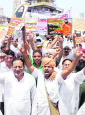 Activists of the Bharat Swabhiman Trust, VHP, BJP and social organisations protest in Karnal on Sunday.