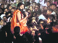 Ramdev addresses his supporters moments before the police raid on the venue