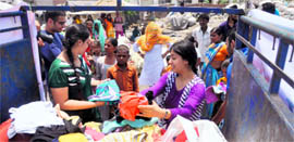 Teenaged members of NGO Jeevan Sanyam distribute clothes to slum kids in Ludhiana.
