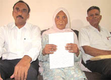 Kartar Kaur with the copy of the court order. 
