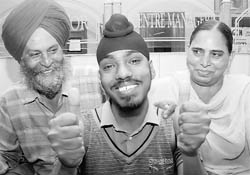 Gurpreet Singh clelebrates with his parents after the PSEB Class XII results were declared 