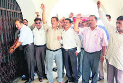 Striking ministerial collectorate employees lock their office in protest against the non-fulfilment of their demands in Dehradun 