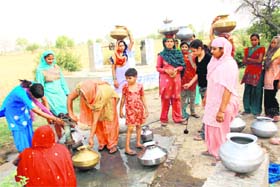 Women queue up to fill water from a handpump at Brahmanwas village in Rohtak district
