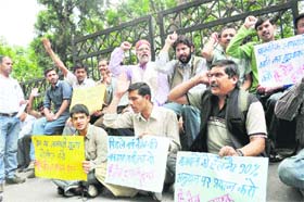 Apple growers stage a demonstration against the government in Shimla on Monday