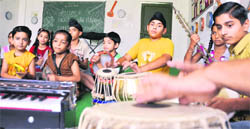 Students of HVM Convent School take music classes as a part of the summer camp in Ludhiana on Monday.