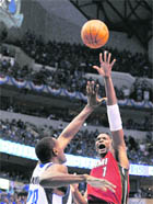 Chris Bosh #1 of the Miami Heat attempts a shot against Ian Mahinmi of the Dallas Mavericks in Game Three of the NBA Finals at American Airlines Center in Dallas on Sunday. 