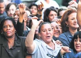 THUMBS DOWN: Members of the New York Hotel Workers Union boo at former IMF chief Dominique Strauss-Kahn as he arrives at New York Supreme Court on Monday