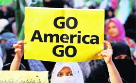 A woman supporter of Jamaat-e-Islami takes part in a rally against drone strikes in Karachi