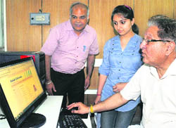 Vice-Chancellor RC Sobti shows the demo of online admission website for BCom to a student at Panjab University on Tuesday. 