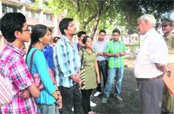Prof Naval Kishore listens to BBA-I students of GCM, Sector 11, at Panjab University, as they register a protest after their annual result was declared on Tuesday.