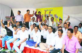 Ameens of the Revenue Department hold a dharna in front of the state Assembly in Dehradun on Tuesday