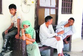 A family that had come to the Collectorate for some work waits on a bench as ministerial employees are on an indefinite strike in Dehradun on Tuesday