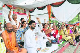 Supporters of Ramdev hold a dharna in his support at Gandhi Park, Dehradun, on Tuesday. 