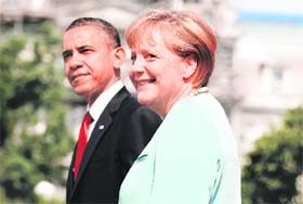 POWER POLES: German Chancellor Angela Merkel smiles next to US President Barack Obama at the podium during an official state arrival ceremony at the White House in Washington on Tuesday